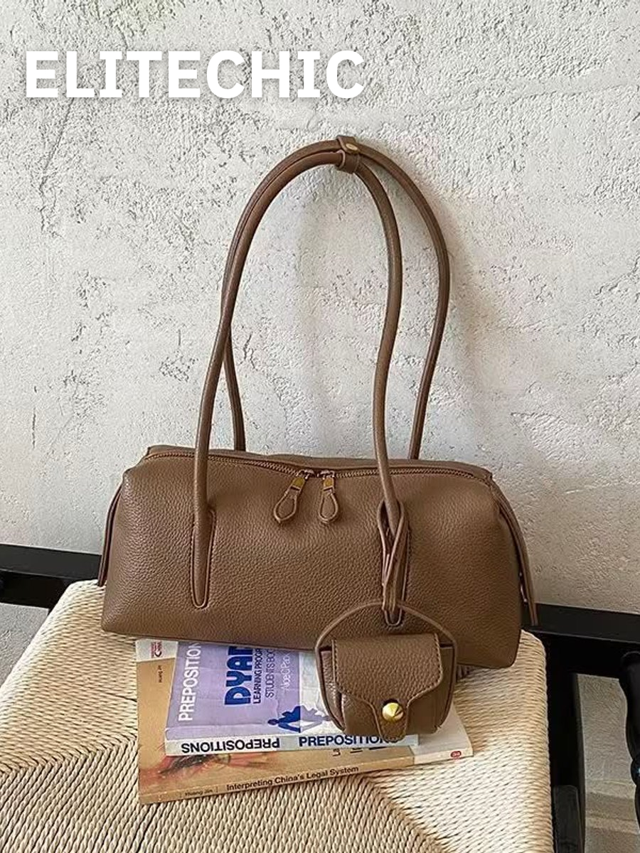 Túi trống da màu nâu bò trên ghế